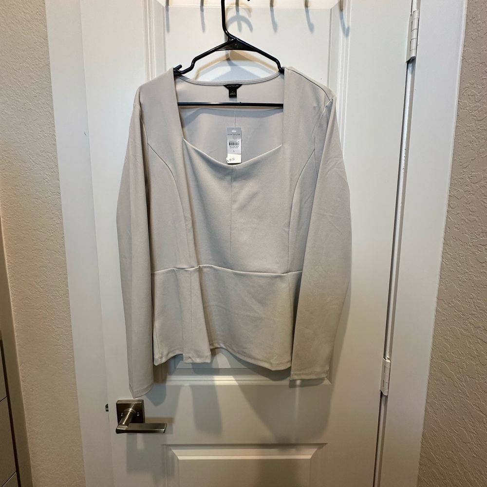 Ann Taylor grey long sleeve peplum top. Size L